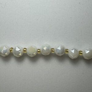 White faceted beads and gold spacers.