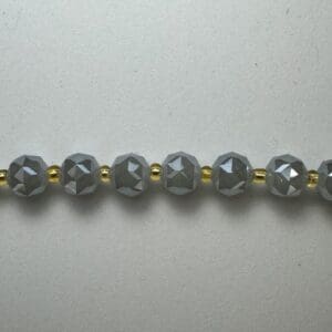 Gray faceted beads and gold spacers.