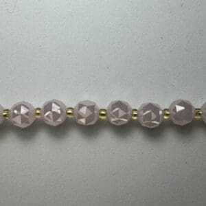 Pink faceted beads gold spacer necklace.