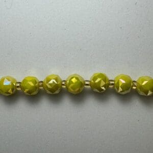 Lime green faceted beads on string.