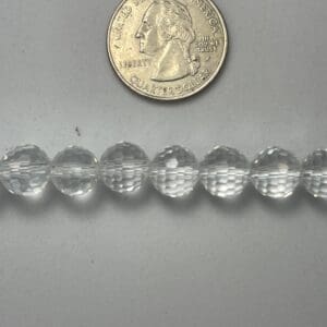 Clear glass beads with quarter for scale.