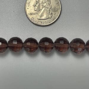 Brown faceted glass beads with quarter.