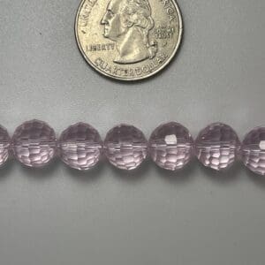 Pink faceted glass beads with quarter.