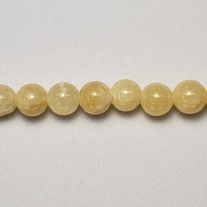 Small glossy yellow round gemstone bead strand