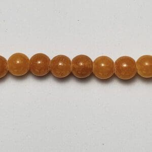 4mm amber round beads on white