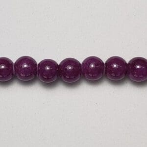 Purple round gemstone beads strand.