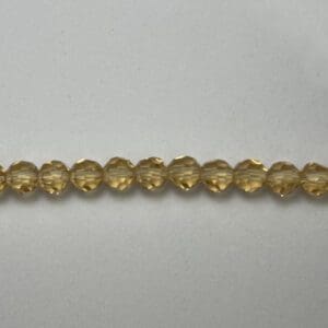 Faceted pale honey yellow round beads