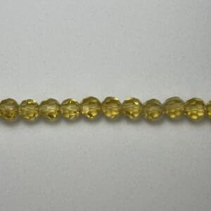 Yellow faceted glass beads strand.