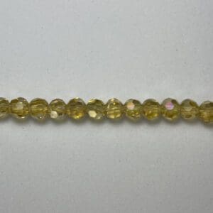 Here's an alt tag for the image: Yellow glass beads strand.