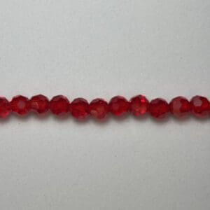 Here's an alt tag for the image: Red glass beads in a row.