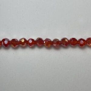 Tiny faceted red AB glass beads