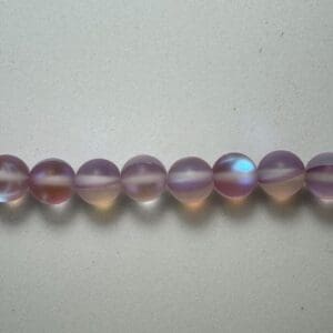 Row of iridescent purple glass beads.