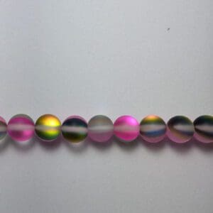 Row of iridescent pink glass beads.