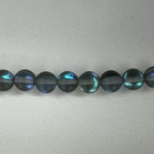 Row of iridescent dark gray beads.