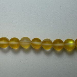 Yellow glass beads in a row.