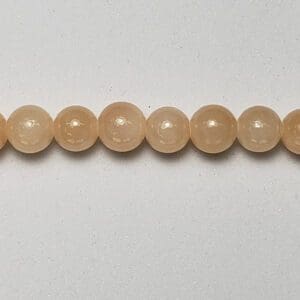Polished apricot beads lined horizontally