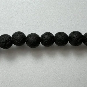 Black lava rock beads on white.
