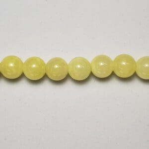 Pale yellow round gemstone beads.
