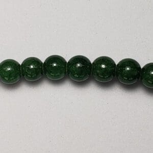 Dark green round beads in a row.