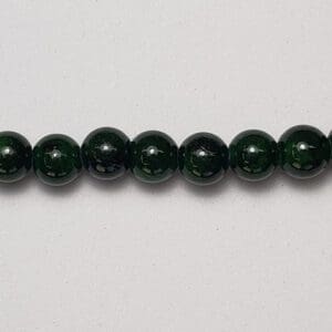 Dark green round beads strand.
