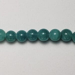 Teal gemstone beads on white background.