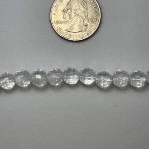 Clear glass beads with quarter for scale.