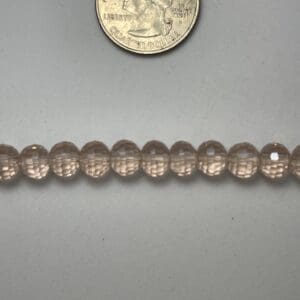 Row of light pink glass beads.