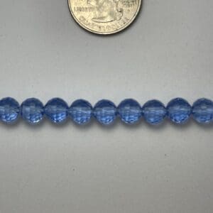 Light blue glass beads with quarter.