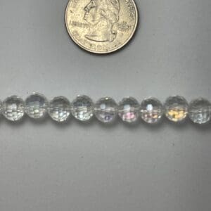 Clear glass beads with quarter for scale.