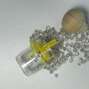 Glass bottle, beads, wooden top, yellow bow.