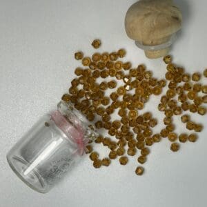 Amber glass beads spilling from jar.