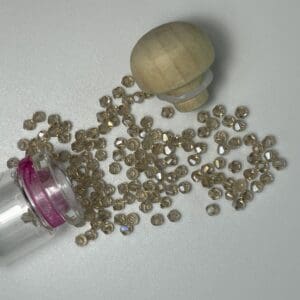 Scattered glass beads and wooden lid.
