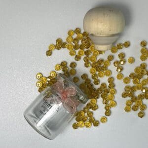 Amber beads, small bottle, wooden top.