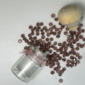 Mauve glass beads in jar and container.