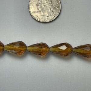 Amber teardrop glass beads, size comparison.