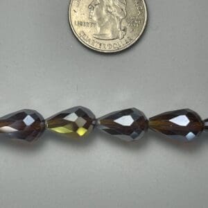 Smoky quartz teardrop beads with a quarter.