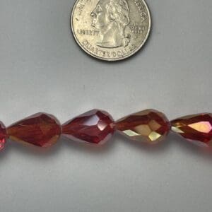 Red teardrop glass beads with quarter.