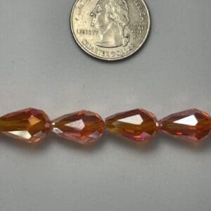 Amber teardrop glass beads with quarter.