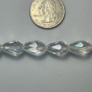 Clear faceted glass beads with quarter.