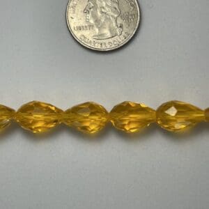 Amber glass beads with quarter for scale.