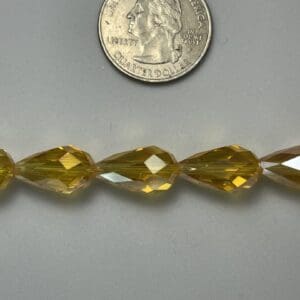 Amber teardrop glass beads with quarter.