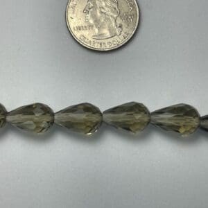Smoky quartz teardrop beads and quarter.