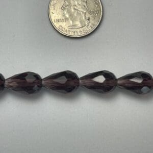 Dark purple teardrop glass beads.