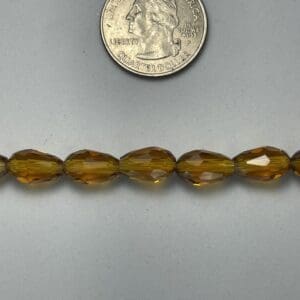 Amber glass beads with quarter for scale.