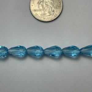 Light blue teardrop beads size comparison.