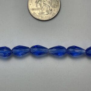Row of cobalt blue faceted beads.