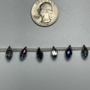 Five iridescent teardrop beads displayed.