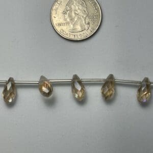 Smoky quartz teardrop beads with quarter.