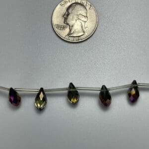 Dark iridescent pear-shaped beads.