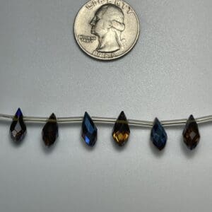 Six teardrop crystal beads on wire.